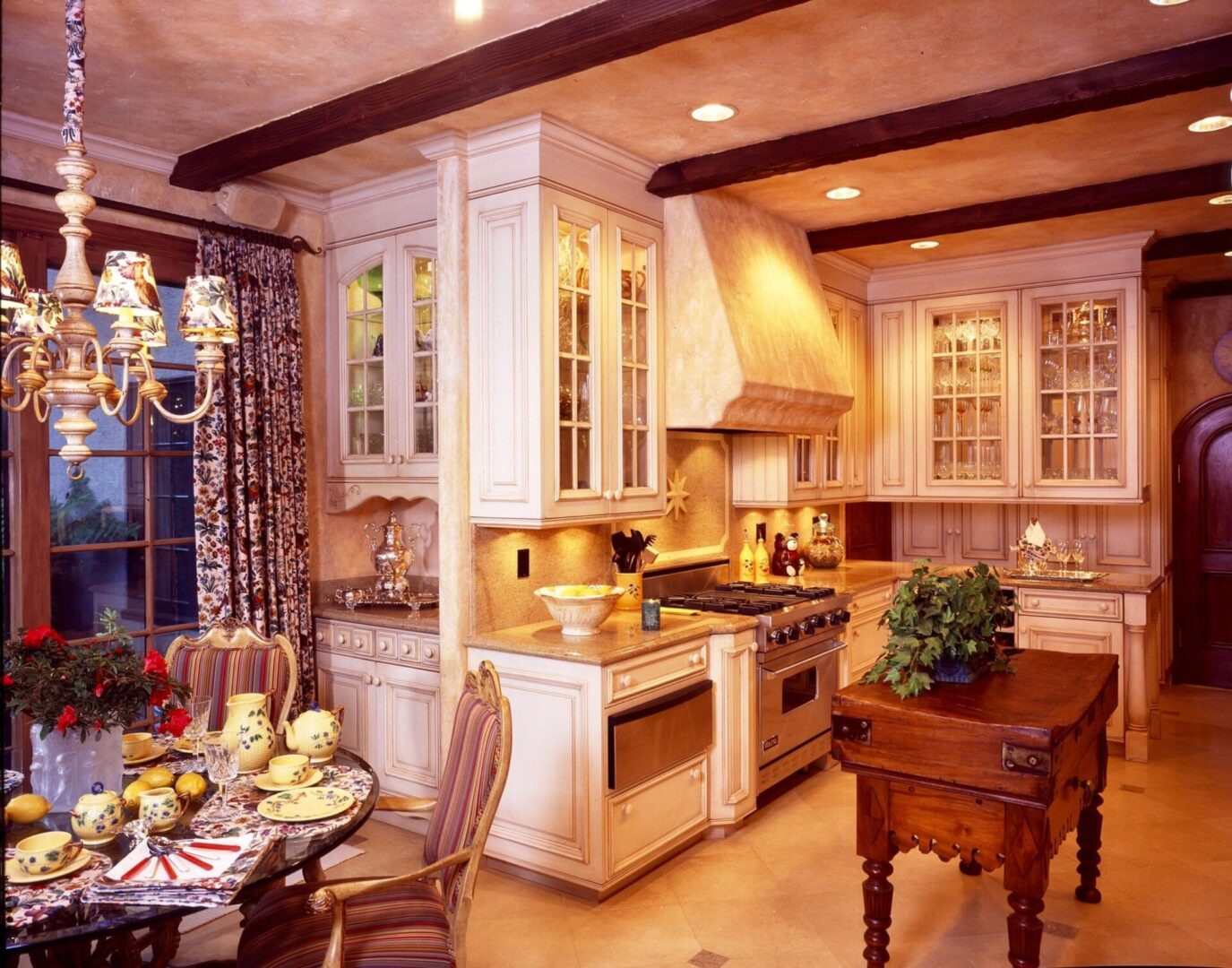 A kitchen with white cabinets and wooden floors.